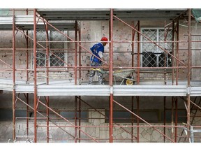 Construction workers of Olytecma Italia work on scaffolding on residential building sites in Rome, Italy, on Monday, Feb. 21, 2022. Rome, Milan and cities across Italy have become clogged with scaffolding after real-estate owners rushed to tap generous government programs to fund energy-efficiency renovations.