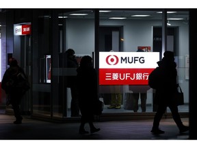 Illuminated signage for MUFG Bank Ltd., a unit of Mitsubishi UFJ Financial Group Inc. (MUFG), displayed outside a branch at night in Tokyo, Japan, on Wednesday, Jan. 25, 2023.  Photographer: Kiyoshi Ota/Bloomberg