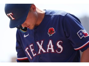 DETROIT, MICHIGAN - MAY 29: Corey Seager #5 of the Texas Rangers prepares to bat on the first inning with a red poppy on the left side of his jersey with Lest We Forget in honor of Memorial Day while playing the Detroit Tigers at Comerica Park on May 29, 2023 in Detroit, Michigan.