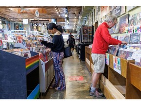 Shoppers browse albums at a record store in Atlanta, Georgia, US. Photographer: Dustin Chambers/Bloomberg