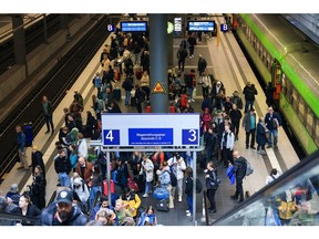 Passengers make their way to the concourse after arriving at Berlin Central Station in Berlin, Germany, on Tuesday, May 16, 2023. Germany averted a nationwide train strike after state-owned Deutsche Bahn took the EVG union to labor court in a bid to resolve wage talks that have been dragging on for almost three months.