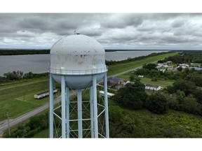 PORT SULPHUR, LOUISIANA - OCTOBER 12: In an aerial view, a water tower stands over homes along the banks of the Mississippi River on October 12, 2023 in Port Sulphur, Louisiana. As a saltwater intrusion from the Gulf of Mexico continues to push its way up the drought-stricken Mississippi River towards New Orleans, the U.S. Army Corps of Engineers are using pipes to move dredged silt to fortify an underwater sill along the bottom of the Mississippi River that should slow the movement of the saltwater wedge. The U.S. Army Corps of Engineers started barging fresh water to water treatment facilities in Plaquemines Parish to help dilute the salinity content to levels safe for water treatment. If the saltwater intrusion isn't slowed it could find its way upriver to the New Orleans area by the end of October, threatening fresh drinking water for residents.