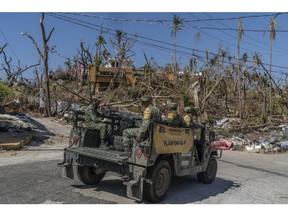 Members of the army patrol in the aftermath of Hurricane Otis in Acapulco, Guerrero state, Mexico, on Tuesday, Nov. 14, 2023. Mexico's lower house of Congress approved the spending portion of the 2024 budget and sent it to the president for signing, without including extra funding for the recovery of hurricane-hit Acapulco. Photographer: Alejandro Cegarra/Bloomberg