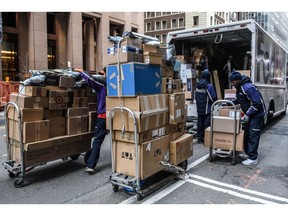 Drivers for an independent contractor to FedEx deliver packages on Cyber Monday in New York, US, on Monday, Nov. 27, 2023. An estimated 182 million people are planning to shop from Thanksgiving Day through Cyber Monday, the most since 2017, according to the National Retail Federation.