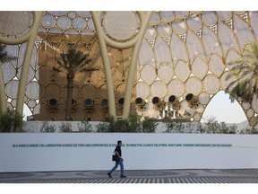 An attendee walks across a plaza in Expo City in Dubai ahead of the COP28 climate conference. Photographer: Hollie Adams/Bloomberg