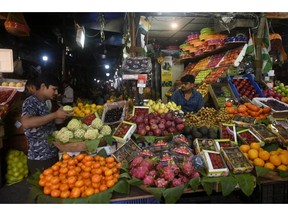 A customer browses fruit at a market stall in Mumbai, India, on Wednesday, Dec. 6, 2023. India's stock market value reached more than $4 trillion Tuesday for the first time, marking a key milestone for the world's fifth-biggest equity market as it rapidly narrows the gap with slumping Hong Kong.