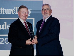 President and CEO of Bob's Discount Furniture Bill Barton accepts the award from Furniture Today's editor-in-chief Bill McLoughlin