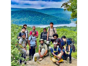 2023 Crawford Prize recipient Manny Almonte (bottom center) with Camping to Connect mentors and participants. Camping to Connect's goal is to change the narrative of who belongs in outdoor spaces and to help young men of color unlock their potential. Photo courtesy of Young Masterminds Initiative.