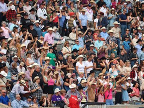 Crowds in the grandstand watch the Calgary Stampede rodeo in July. More than 17,000 people from other parts of the country moved to Alberta from July to September this year.