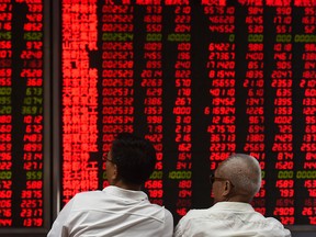 Investors monitor stock price movements in Beijing. Since peaking at 235 billion renminbi (US$33 billion) in August, net foreign investment in China-listed shares this year has dropped 87 per cent.