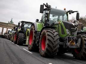 Farmers with tractors take part in a protest rally organized by the German Farmers' Association in Berlin, Germany, Monday, Dec. 18, 2023. Farmers are gathering in Berlin to protest against planned cuts to tax breaks for diesel used in agriculture, part of a deal reached by the government to plug a hole in the country's budget.