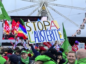 FILE - A protestor holds a sign which reads 'stop austerity' during a demonstration against austerity measures in Brussels, Tuesday, Dec. 12, 2023. European Union finance ministers on Wednesday, Dec. 20, 2023, sealed a deal to reform the 27-nation bloc's fiscal rules after France and Germany finally adhered to a compromise. EU countries had been negotiating for months a reform of the bloc's fiscal rules limiting debt and deficits for member states, known as the Stability and Growth Pact.