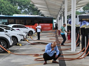 Drivers wait for their electric vehicles to charge at Antuoshan charging station in Shenzhen, China's southern Guangdong province.