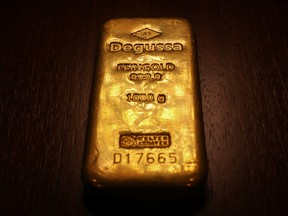 A gold bar displayed in a showroom in London. Gold surged to its highest ever price — US$2,135 per ounce — for a brief period on Dec. 3.