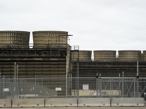 FILE - Cooling towers release heat generated by boiling water reactors at Xcel Energy's Nuclear Generating Plant, Oct. 2, 2019, in Monticello, Minn. Xcel Energy has been fined $14,000 related to leaks of radioactive tritium from its nuclear power plant at Monticello, Minnesota regulators announced Thursday, Dec. 14, 2023.