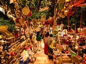 Customers look at decorative items displayed for sale at a shop in New Delhi, India, ahead of Christmas celebrations.
