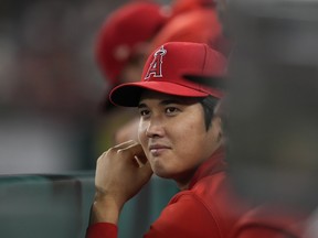 Los Angeles Angels' Shohei Ohtani sits in the dugout during the tenth inning of a baseball game against the Detroit Tigers in Anaheim, Calif., on Sept. 16.