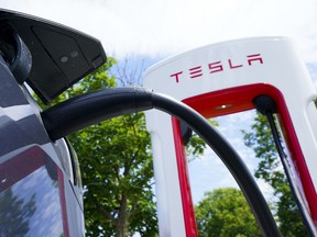 An electric vehicle is charged at a Tesla Inc. charging station in Ottawa.