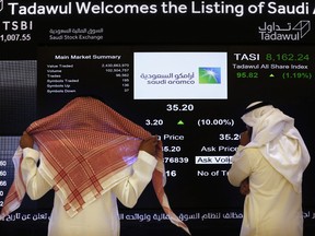Saudi stock market officials watch the stock market screen on the Riyadh's stock market in Riyadh, Saudi Arabia.