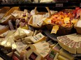 Cheese for sale on a grocery store shelf.