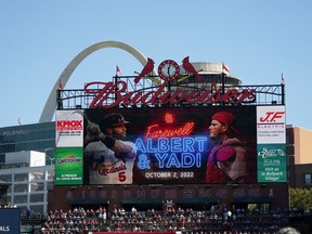 File - a video screen is seen in Busch Stadium as St. Louis Cardinals' Albert Pujols (5) and Yadier Molina (4) are honored during a ceremony before the start of the Cardinals' final regular season baseball game Sunday, Oct. 2, 2022, against the Pittsburgh Pirates in St. Louis. The Cardinals and the world's leading brewer, Anheuser-Busch, announced, Wednesday, Dec. 13, 2023 that the two historic St. Louis institutions have agreed to a five-year extension of their long-term marketing agreement through 2030.