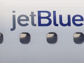 FILE - In this Jan. 20, 2011, file photo, a JetBlue logo is displayed on the side of a jet as it taxis at Boston's Logan International Airport. Federal investigators are describing a close call between planes at a Colorado airport last year. The National Transportation Safety Board said Wednesday, Dec. 13, 2023 that a JetBlue plane struck its tail on the ground because the captain took off quickly to avoid a plane that was preparing to land on the same runway.