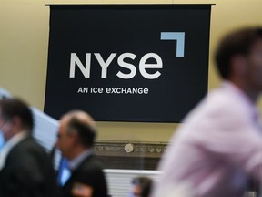 FILE - An NYSE sign is seen on the floor at the New York Stock Exchange in New York, Wednesday, June 15, 2022.