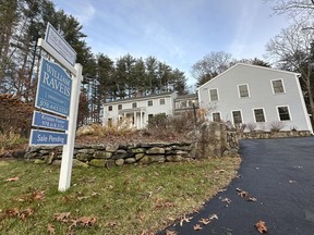 A sale pending sign is displayed in front of a home in Sudbury, Mass. on Saturday, Dec. 2, 2023. On Wednesday, the National Association of Realtors reports on existing home sales for November.