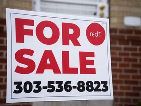 A for sale sign stands outside a single-family residence on Thursday, Nov. 23, 2023, in Denver. On Thursday, Freddie Mac reports on this week's average U.S. mortgage rates.