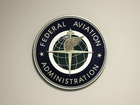 FILE - A Federal Aviation Administration sign hangs in the tower at John F. Kennedy International Airport, March 16, 2017, in New York. The federal government will propose to require drug and alcohol testing for employees of foreign aircraft-repair shops outside the United States. That would bring foreign repair shops under the same rules that apply to workers in the U.S. The Federal Aviation Administration said Wednesday, Dec. 6, 2023 that it will publish its proposal this week and allow 60 days for public comment.