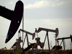 Oil pumpjacks work in a field near Lovington, N.M.