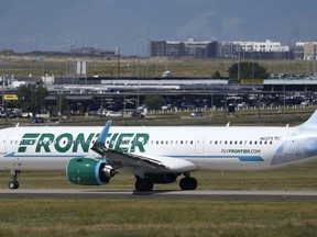 FILE - A Frontier Airlines jetliner waits on a runway for departure from Denver International Airport, Sept. 1, 2023, in Denver. Frontier Airlines has settled a lawsuit filed on behalf of pilots who said the airline discriminated against pregnant and breastfeeding employees. In the settlement announced Tuesday, Dec. 5, 2023 Frontier will let pilots pump breast milk in the cockpit during "noncritical phases" of flights.