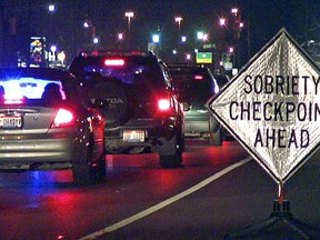 FILE - A sign warns motorists as they approach a sobriety checkpoint on State Route 4 in Fairfield, Ohio June 15, 2007. U.S. auto safety regulators say they have taken the first step toward requiring devices in vehicles that prevent drunk or impaired driving. The National Highway Traffic Safety Administration announced on Tuesday, Dec. 12, 2023, that it is starting the process to put a new federal safety standard in place requiring the technology in all new passenger vehicles.