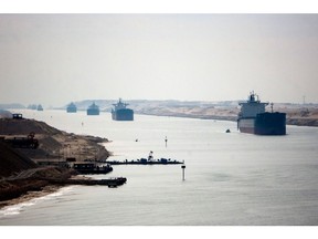 Cargo vessels from the Red Sea in the Suez Canal. Photographer: Camille Delbos/AFP/Getty Images