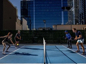 Pickleball players compete at a club in Austin, Texas. Some companies are replacing traditional Christmas parties with events featuring pickleball or other non-holiday activities.