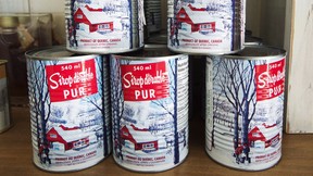 Cans of maple syrup at a sugar shack in Quebec.