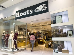 A shopper enters a Roots clothing store