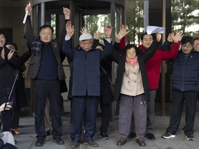 Family members of victims react outside the Supreme Court of Korea in Seoul, South Korea, Thursday, Dec. 28, 2023. South Korea's top court on Thursday ordered a third Japanese company to compensate some of its former wartime Korean employees for forced labor, the second such ruling in a week.