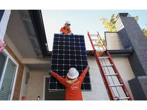 Baker Home Energy workers install solar panels on the roof of a home in Poway. Photographer: Sandy Huffaker/Bloomberg