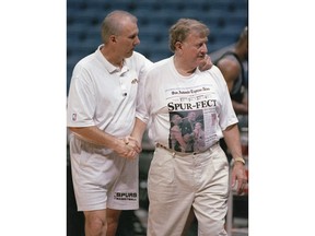 FILE - San Antonio Spurs head coach Greg Popovich, left, shakes hands with San Antonio businessman and former Spurs owner Red McCombs, Saturday, June 12, 1999, during the Spurs' practice at the Alamodome in San Antonio, Texas. The McCombs family has purchased a share of the San Antonio Spurs, returning after 30 years to the organization their patriarch helped establish and once owned.