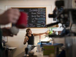 A barista serves a pastry at a coffee shop in Washington, D.C.