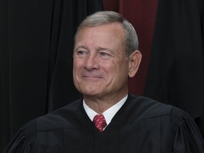 FILE - Chief Justice of the United States John Roberts joins other members of the Supreme Court as they pose for a new group portrait, at the Supreme Court building in Washington, Friday, Oct. 7, 2022.