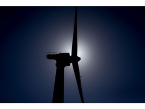 The silhouette of an Ørsted wind turbine in the water off Block Island, Rhode Island, U.S., on Wednesday, Sept. 14, 2016. The installation of five 6-megawatt offshore-wind turbines at the Block Island project gives turbine supplier GE-Alstom first-mover advantage in the U.S. over its rivals Siemens and MHI-Vestas. Photographer: Eric Thayer/Bloomberg