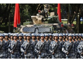 People's Liberation Army (PLA) troops stand in formation during a visit by Chinese President Xi Jinping, not pictured, at the Shek Kong Barracks in Hong Kong, China, on Friday, June 30, 2017. Xi sought to reassure a divided Hong Kong of China's continued support for the former British colony, as pro-democracy protesters struggled to be heard behind road blocks and police lines.