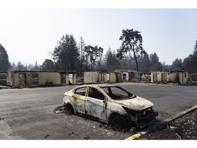 A burnt vehicle sits in the parking lot of a motel destroyed from wildfires in Gates, Oregon, U.S., on Sunday, Sept. 20, 2020. Wildfires have burned nearly 5 million acres, killed at least 27 people, and forced hundreds of thousands to evacuate up and down the West Coast.