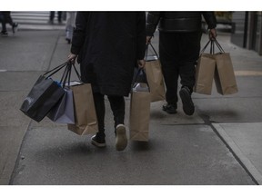 Shoppers carry bags in New York. Photographer: Victor J. Blue/Bloomberg