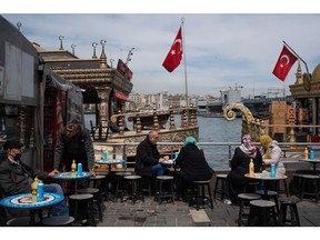 Diners at a terrace outside a port-side cafe in Istanbul. Photographer: Erhan Demirtas/Bloomberg