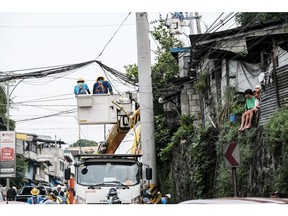 Manila Electric Co. (Meralco) workers repair damaged power lines in Quezon City, Metro Manila, the Philippines, on Thursday, July 28, 2022. The Philippines gets about 57% of its electricity from coal, burning the equivalent of 29 million tons of high quality fuel, according to data from BloombergNEF and BP Plc.
