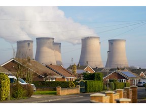 Residential housing near cooling towers at Drax Power Station, operated by Drax Group Plc, where coal-fired units 5 and 6 have been put on standby to generate electricity supplies during a cold snap, near Selby, UK, on Monday, Jan. 23, 2023. Drax Power station is one of three stations that negotiated a winter contingency contract with National Grid Plc for this winter following a request from the government. Photographer: Ian Forsyth/Bloomberg