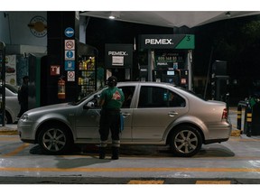 A workers charges a customer at a Petroleos Mexicanos (PEMEX) gas station in Mexico City, Mexico, on Thursday, May 4, 2023. The Mexican government is not currently considering giving state oil company Petroleos Mexicanos a capital injection this year to help pay upcoming debt.